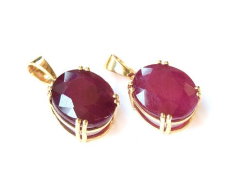 Two 9ct gold and Madagascan ruby pendants, one set with an 11.76ct ruby, 3.5g; the other 11.33cts, 3.6g (2) 