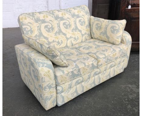 A two seater sofa upholstered in a green fern fabric, 135cmW 