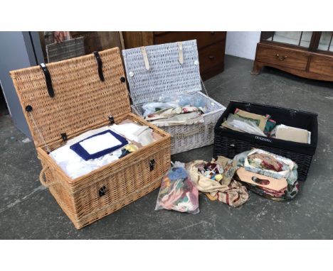 Three wicker hampers, some containing a quantity of fabric, each hamper 64cmW 