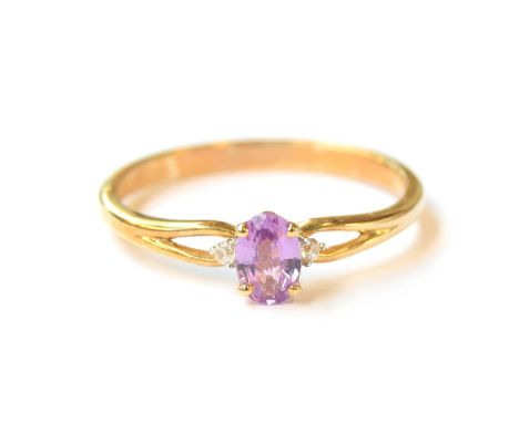 A 9ct gold ring set with a purple sapphire and white natural zircons, the sapphire 0.5cts, size R 1/2, 1.8g 