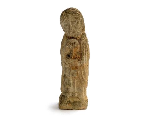 A small Romanesque medieval or later stone carving of Saint Peter holding his key attribute, 14cmH