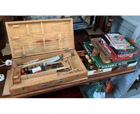 Pine chest with children's tools in together with a small quantity of vintage board games
