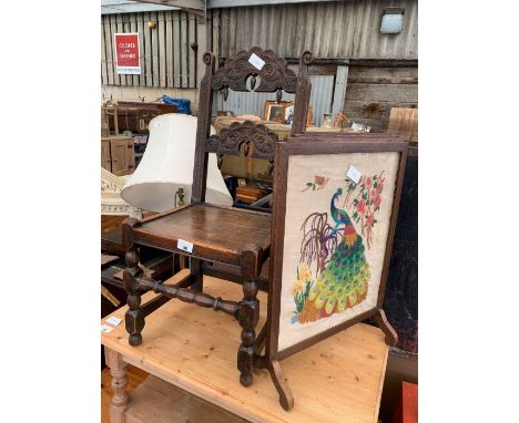 19th Century stained oak hall chair with ornately carved back on 4 legs, together with a framed tapestry fire screen 