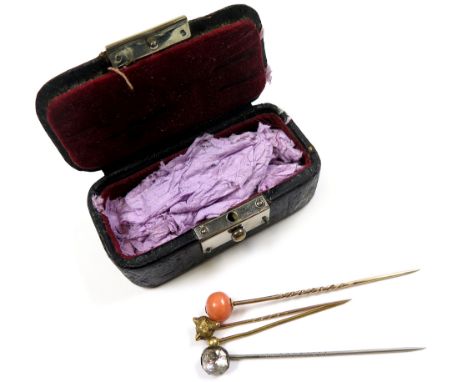 Small box containing 4 stick/tie pins in yellow metal set with stones and a fox head.