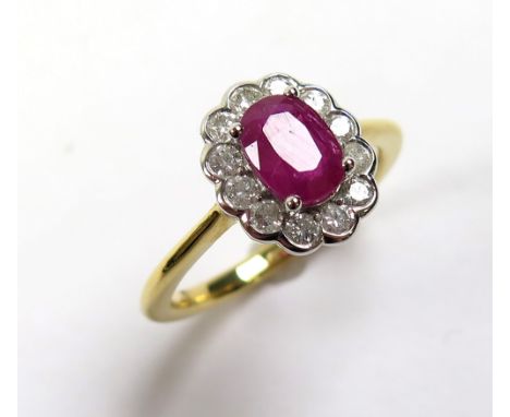 18ct Gold Ring with central Ruby 1.11 ct weight surrounded by Diamonds 0.43 ct weight size M weight 4.4 grams