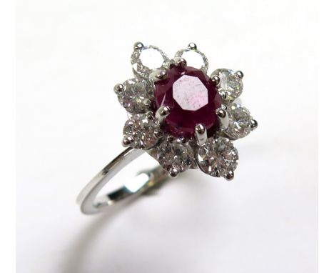 18ct White Gold Ring with central Ruby surrounded by 8 Diamonds size N weight 4.7 grams