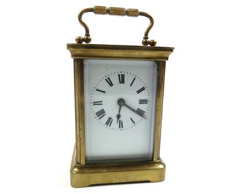 Early 20th Century Brass framed carriage clock with black Roman numerals on a white face. Approx height 11cm (not including h