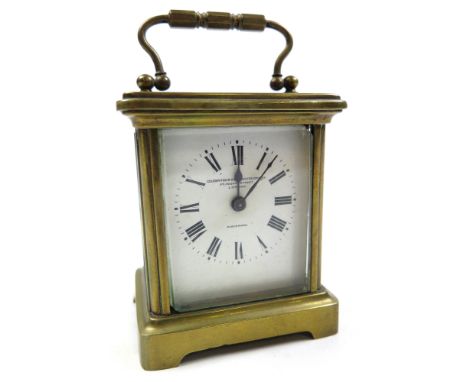 Brass framed carriage clock with black Roman numerals on a white face "Goldsmiths and Silversmiths Co. 112 Regent Street Lond