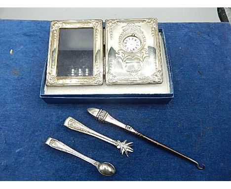 Silver picture frame with clock insert from Carrs, in orighinal box and leaflet, hallmarked sugar tongs, other tongs and a ha