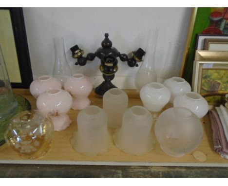 wooden 3 prong ceiling light with a collection of glass fluted shades plus some oil lamp shades