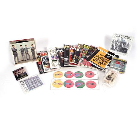 A selection of The Beatles memorabilia, including: a singles carry case; two sets of circular button badges; a set of five gu
