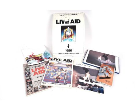 A collectors' bundle of Live Aid memorabilia and ephemera, to include: T-Shirt; Calendar; various programmes; and a number of