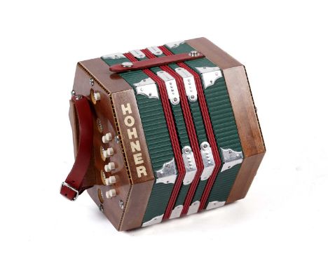 A Hohner 20 button Anglo system concertina, with pass button, mahogany finished case.