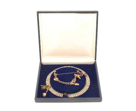 A 9 carat yellow gold curb link bracelet with bolt fastener, five 9 carat yellow gold charms attached; a woodepcker, swan, ga