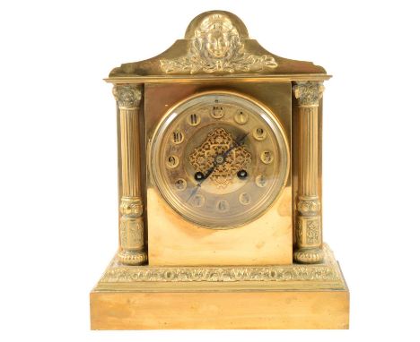 French brass mantel clock, shaped pediment with mask, Corinthian columns flanking the circular dial, plinth base, cylinder mo