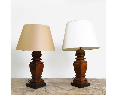 A pair of hardwood balustrade table lamps, of recent manufacture, each of square form on an ebonised plinth, 82cm high overal