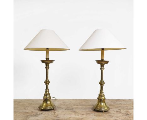 A pair of Victorian brass altar table lamps, each with a knopped stem and a white shade, 82cm high (2)Condition ReportgoodPAT