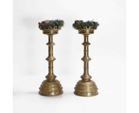 A pair of brass altar candlesticks, 19th century, each with a castellated sconce, turned column, stepped base and presentatio