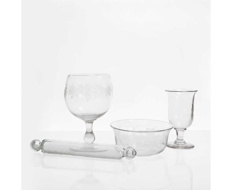 A large glass rummer, engraved with fruiting vine over a baluster stem, 27cm high,a glass rolling pin,37cm long,a lipped bowl