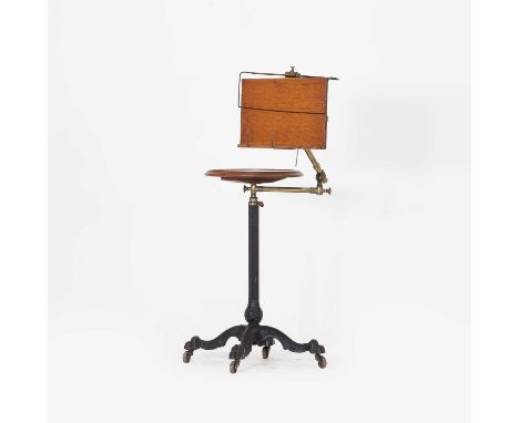 A Victorian cast iron 'Literary Machine' reading table, by John Carter, London, with a circular, height adjustable, mahogany 