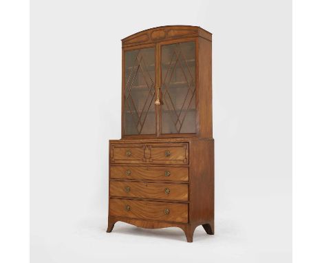 A Regency mahogany secretaire bookcase, c.1810, with a plain arched pediment and angled glazing bars, over a fitted writing d