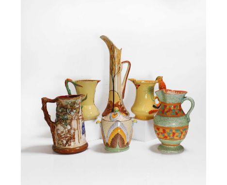 A group of Art Deco pottery jugs and vases, including Sylvac parrot and squirrel jugs, 20 and 22cm high,a Wadeheath jug mould