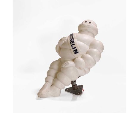 A 'Michelin' Bibendum, 20th century, modelled seated with a 'MICHELIN' sash, with a metal wall mount,26cm wide45cm high
