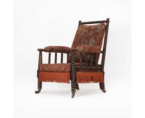 A Victorian faux rosewood bobbin-framed library chair, with later upholstered loose cushion seat and back, on castors, 54cm w