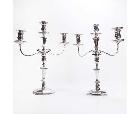 A pair of silver three-branch candelabra, by Crichton Brothers, London 1929, each with scrolling arms on an octagonal stepped