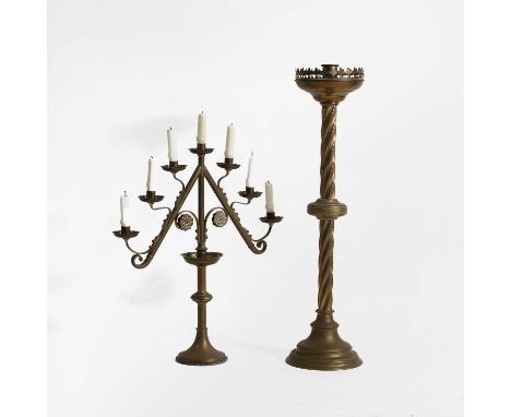 An ecclesiastical brass altar stick, late 19th century, with a Gothic twist column and castellated drip pans,76cm high,togeth