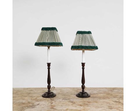 A pair of mahogany table lamps,  20th century, each with a baluster turned column and turned base, with a pleated green shade