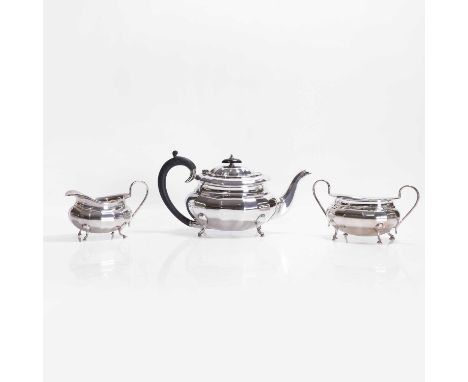 A silver three-piece tea service, by Viners Ltd., London 1935, comprising a teapot with carved wood handle and finial, a suga