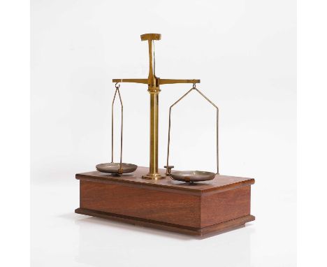 A set of brass balance scales, c.1900, on a mahogany base with drawer,25cm wide15cm deep31cm high