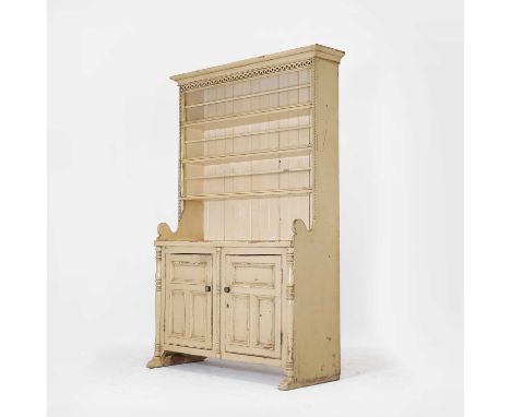 A painted pine dresser, late 19th century, Continental, with a closed plate rack, column sides and panelled doors to the base