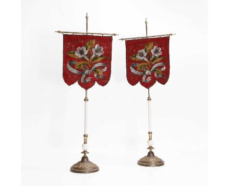 A pair of Victorian beadwork banner screens, c.1870, each brass-framed with a ceramic column and moulding, on a loaded circul