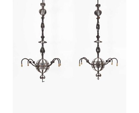 A pair of wrought-iron ceiling lights, 20th century, French, each with spiral decoration and a pierced 'globe' supporting fou