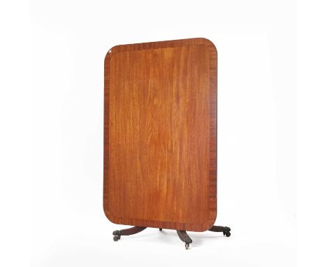 A George III mahogany pedestal dining table, the strung and crossbanded rectangular snap top on a turned column, over four ou
