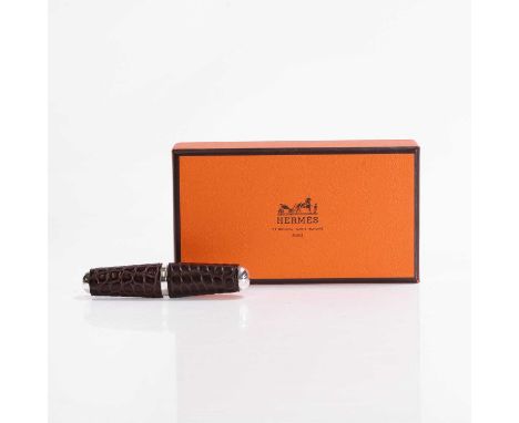 A wine corkscrew by Hermès, Paris, in burgundy crocodile leather, with box,8cm long (2)Condition ReportGood, no receipt or ce