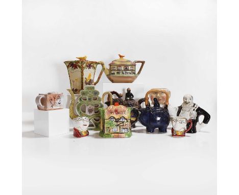 A collection of pottery and porcelain teapots and covers, 20th century, including a blue-glazed example modelled as a Buddha 