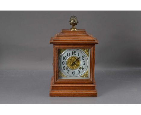 A Early 20th Century Oak Case 8 day Mantel Clock, "Ilion" by the Ansonia clock co. New York USA, silvered face with Arabic nu