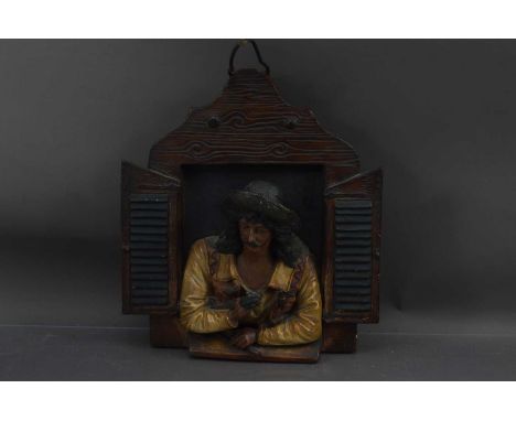 An unusual late 19th Century painted terracotta wall plaque of a musician at a window, possibly Austrian or Tyrolean. Signed 