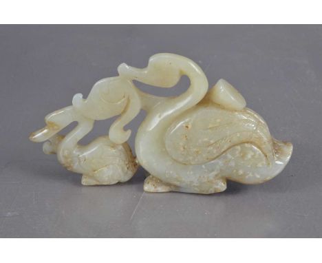 A Chinese jade carving of a swan and signet with a lotus pod, the bird's wings with feather detailing. 10.2 cm long by 5.5 cm