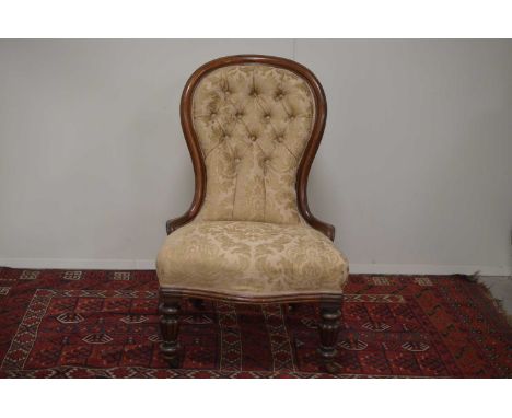 A Victorian button-backed salon or nursing chair English circa 1880s, on turned and fluted legs. Modern upholstered back and 