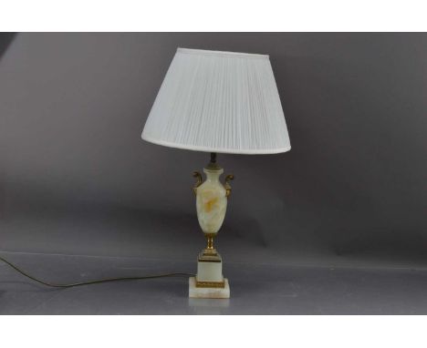 An alabaster and brass  urn shaped table lamp, with a pleated cream silk shade. 41 cm to top of fitting. (60 cm (approx.) to 