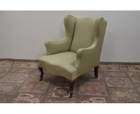 A 19th Century wingback armchair, upholstered in eau de nil fabric. Ceramic casters to feet. 100 cm high by 72 cm wide by 80 