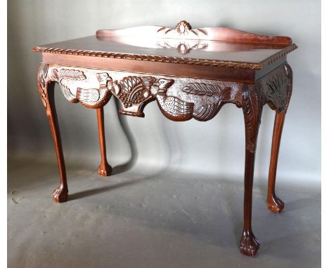 A George III Style Mahogany Console Table by Higginbottom of Dublin with a low galleried back above a carved frieze, raised u