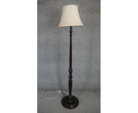 A mid century mahogany standard lamp with flutted and turned column on platform base. H180cm 