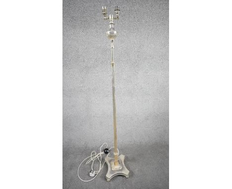 A vintage silver plated height adjustable two bulb standard lamp with reeded column, X-shape base and floral design to the to