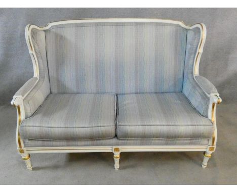 A Louis XVI style gilt and white painted two seater sofa in pale damask upholstery. H.93 L.136 D.77cm 