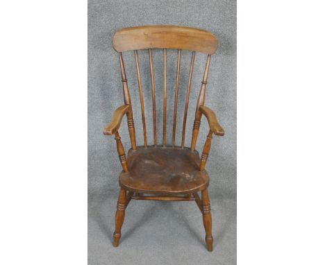 A 19th century beech stick back Windsor armchair with elm seat. 